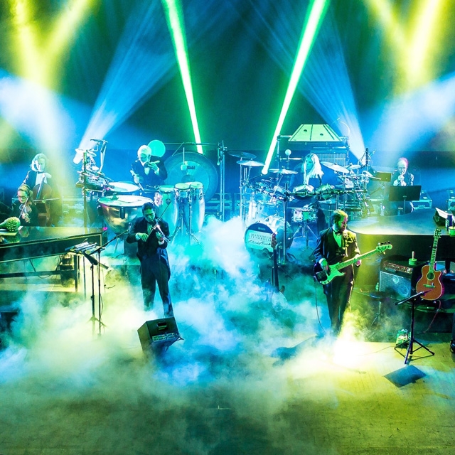 Orchestra playing with colorful lights at Crystal Grand.