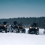 Row of ATVs in snow.
