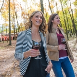 Women enjoying wine outdoors.