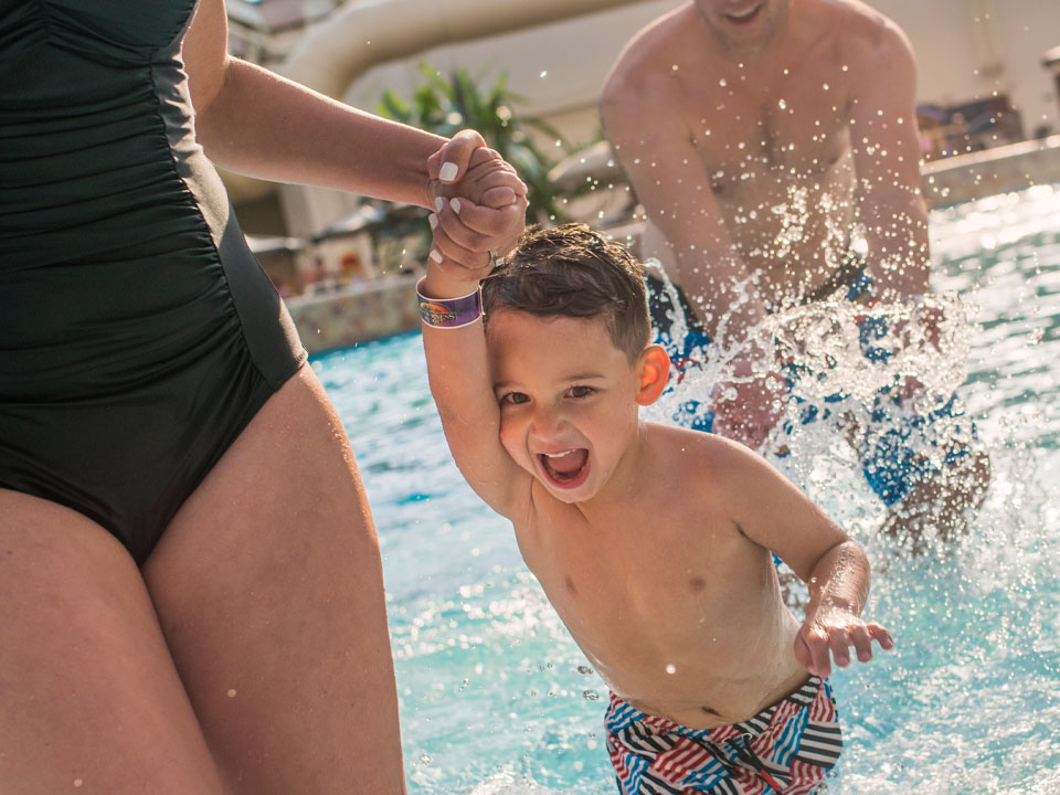 A family splashes at Wilderness indoor waterpark.