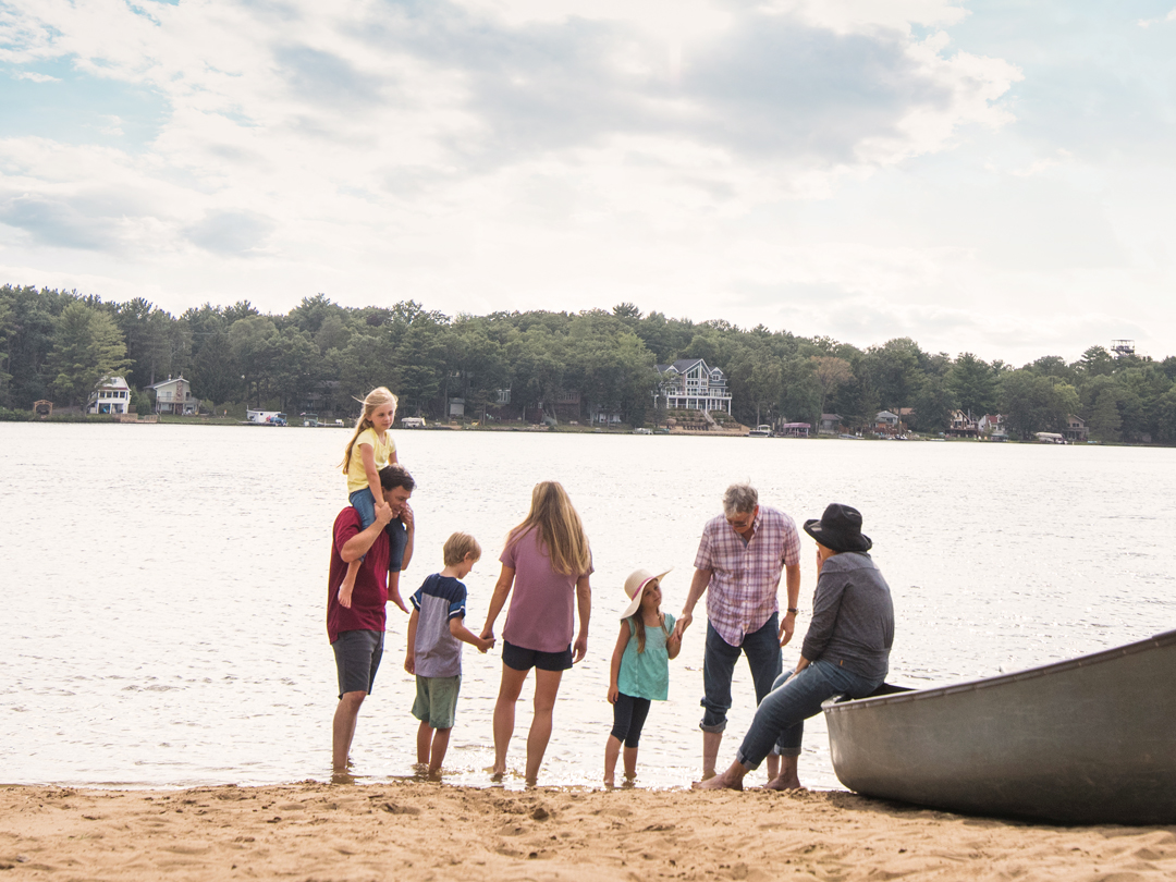 Family with canoe on beach
