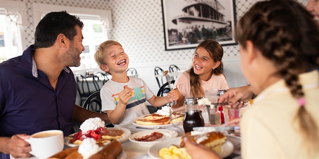family enjoying pancakes