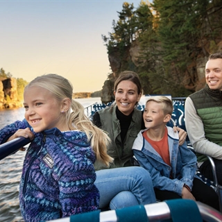 Family on a boat tour watching fall colors.