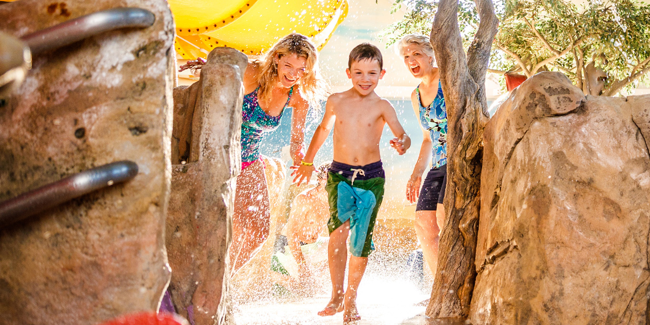 Family playing at an indoor waterpark.