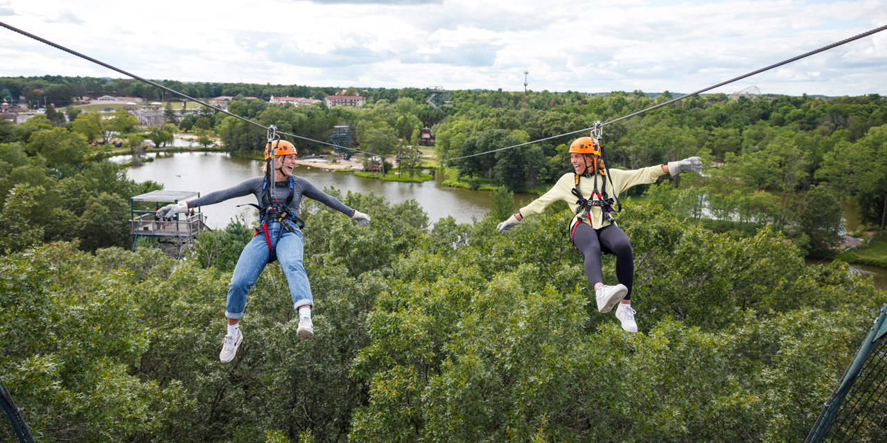 Two woman ziplining.