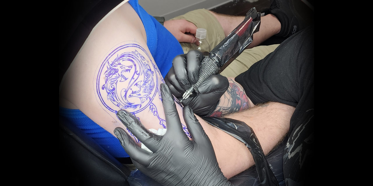 Person getting arm tatood.
