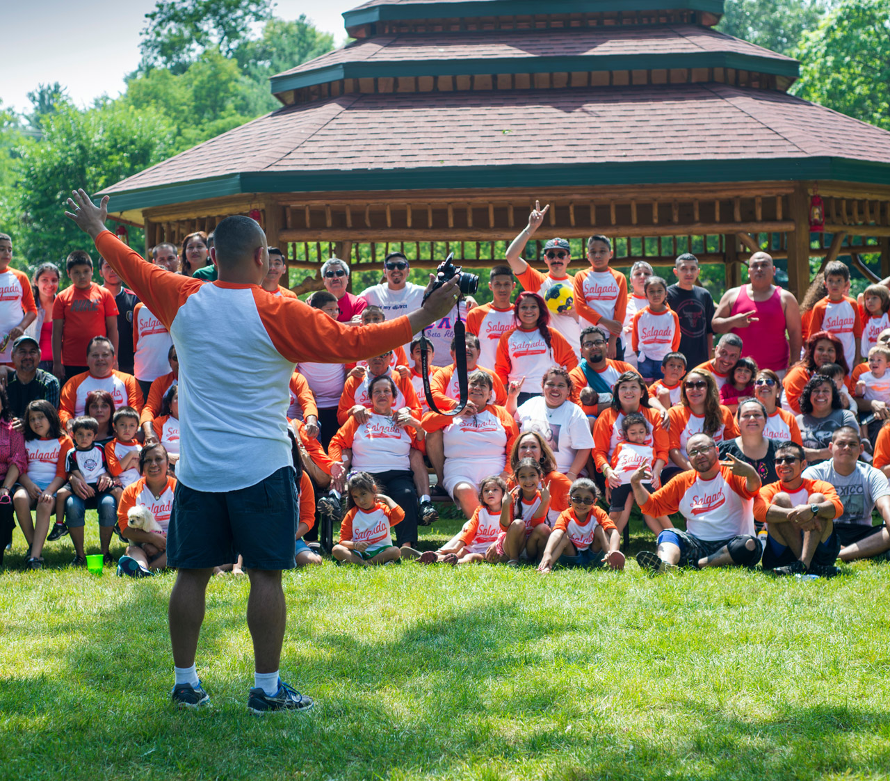 Large group of people in front of a canopy.