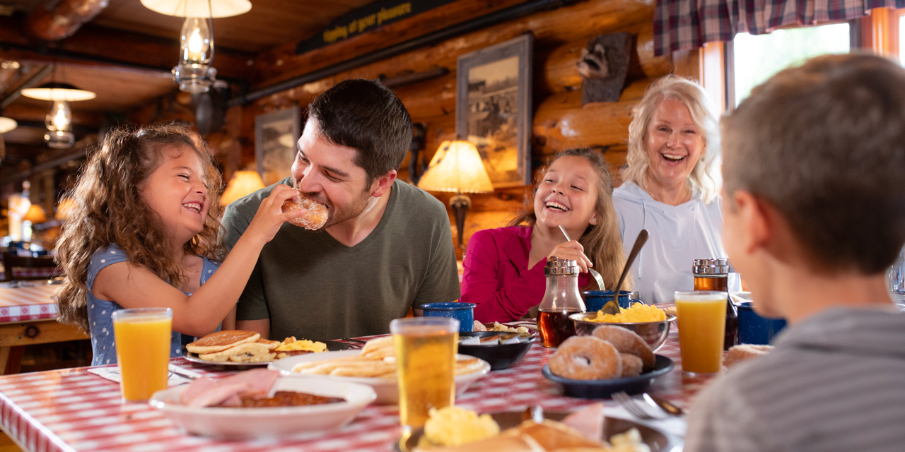 Family eating breakfast with donuts.